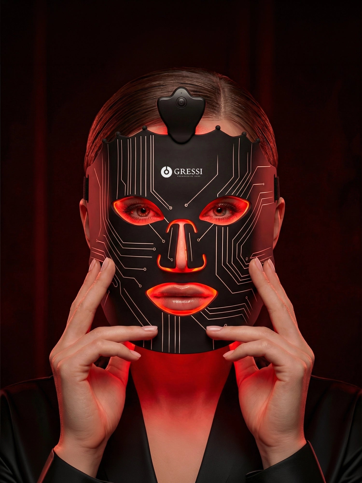 Person wearing a Gressi Switzerland LED face mask with red accents and 'Gressi' branding.